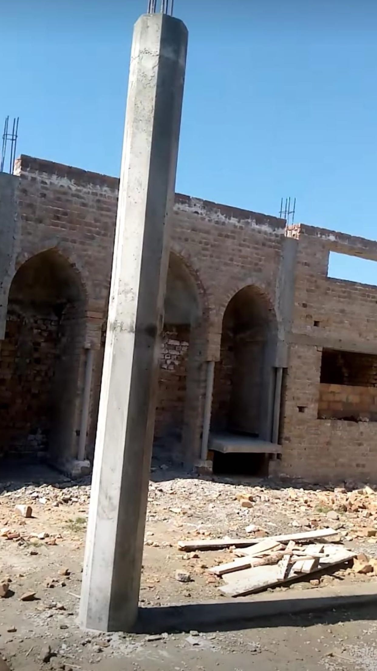Brick archways and concrete columns at the mosque construction site